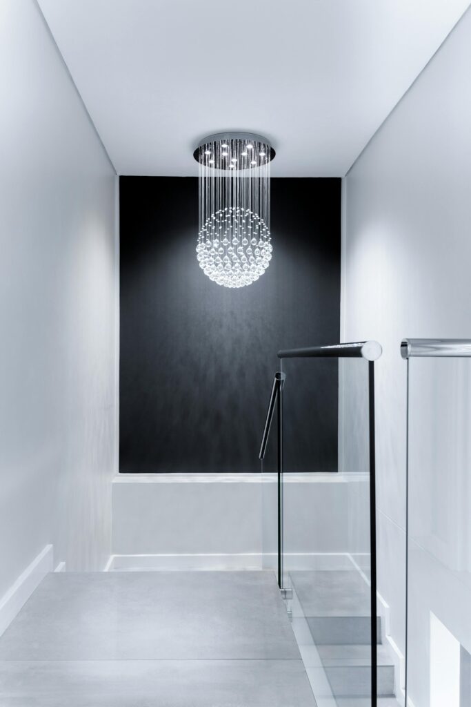 Sleek contemporary hallway featuring a stunning glass chandelier and minimalist design.